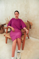 A person wearing a purple swimm dress