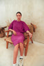 A person wearing a purple swimm dress