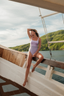 Full-coverage one-piece swimsuit – NAYA model with removable padding, modest cut, and bicolor matte-glossy blend in purple and fairy tale.
