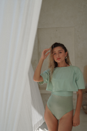 Lightweight modest swim skirt in Sage with a shiny Lichen/Sage adjustable one-piece for elegant beachwear.